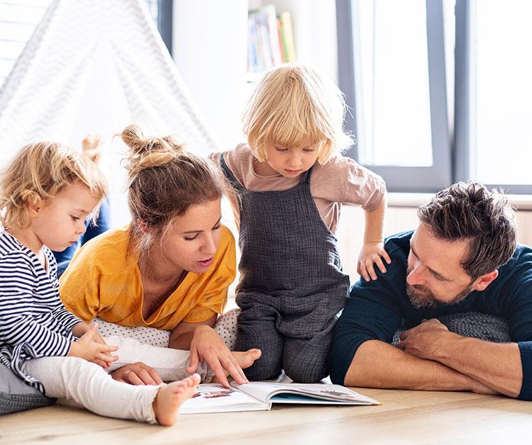 Mom and dad on floor playing with kids