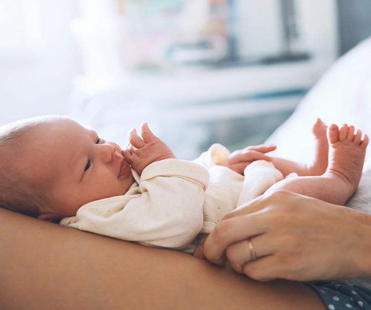 Baby looking up from mother's lap