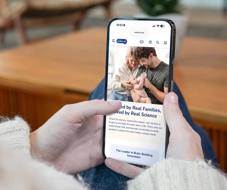 Person looking at enfamil.com on phone