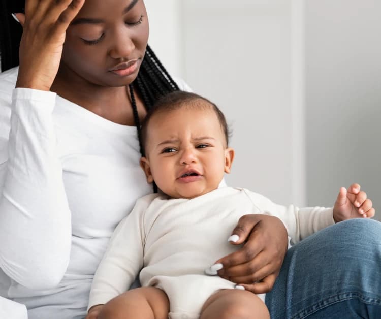 Mom holding fussy baby