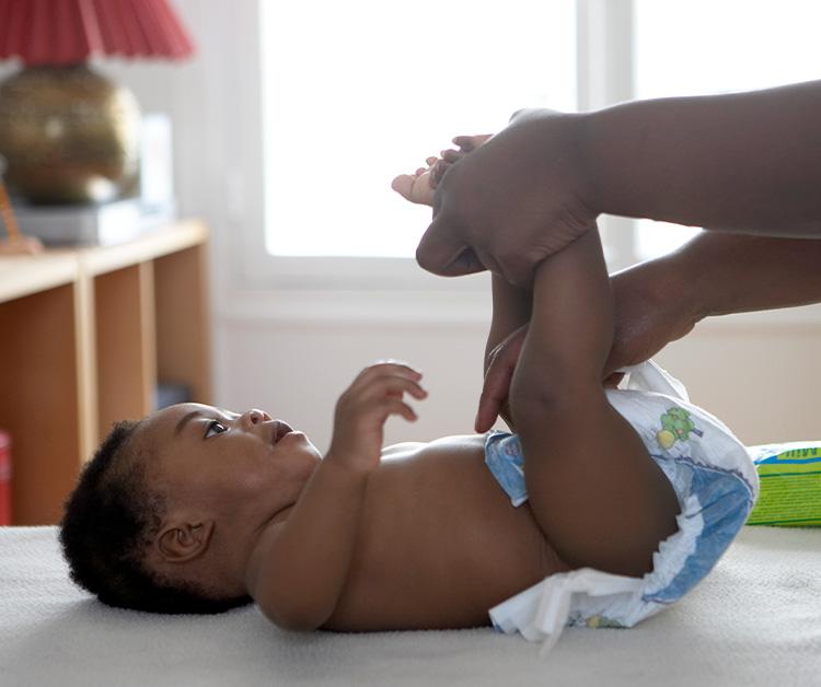 Mom changing baby's diaper