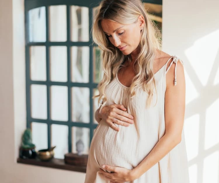 Pregnant mother holding her bump
