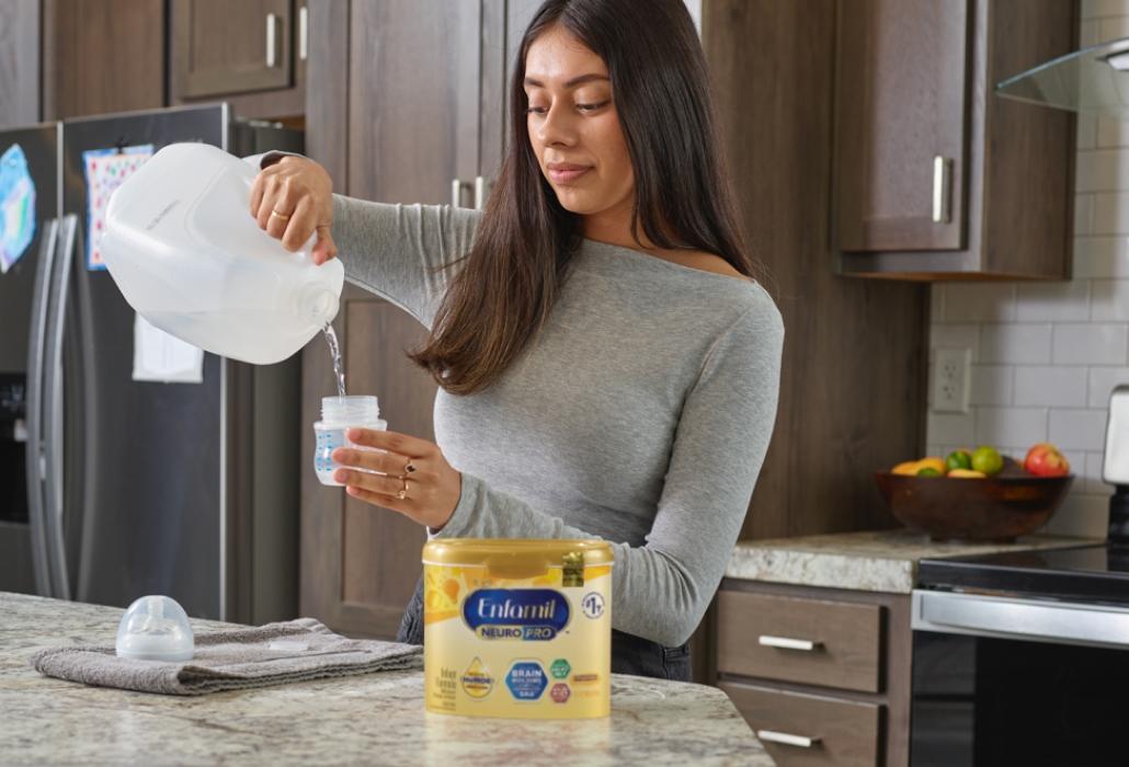 Mom pouring water into bottle