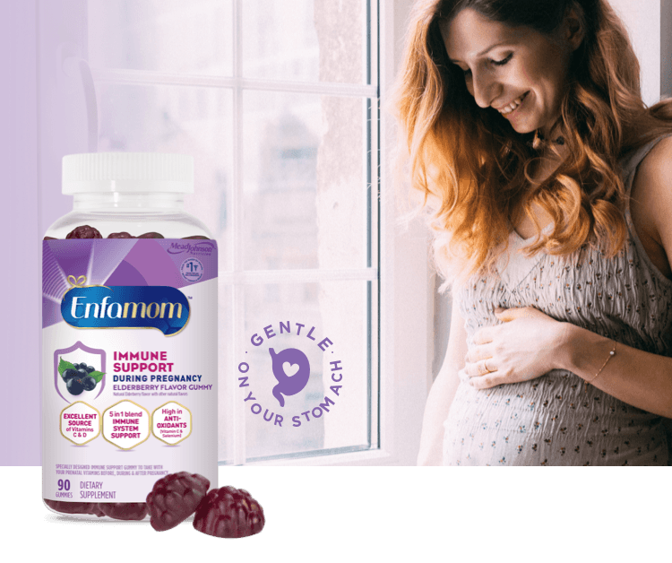 Pregnant mom holding her belly and smiling