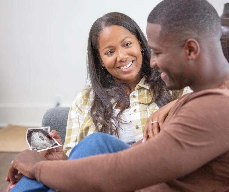 Mom and Dad looking at ultrasound photo