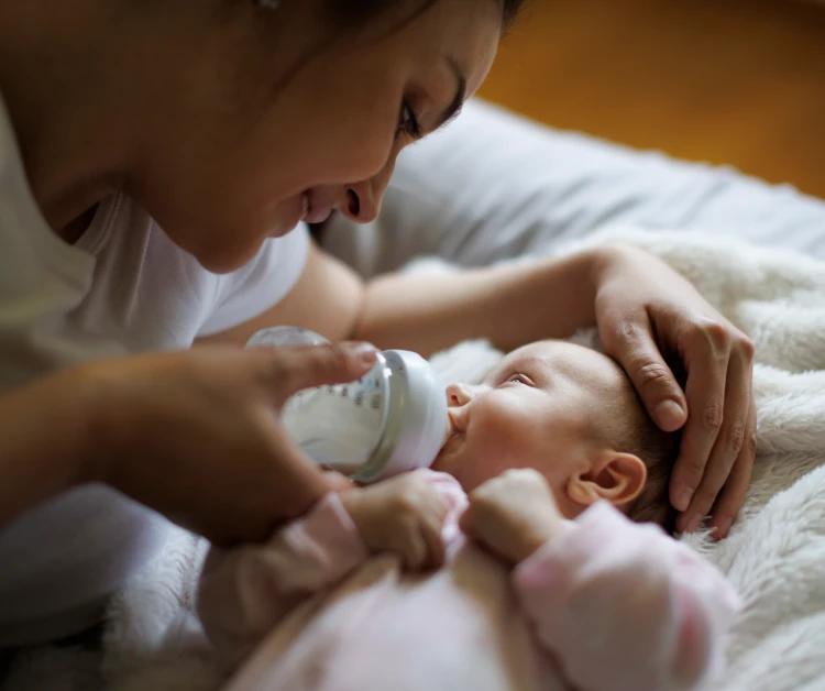 Mother feeding her baby a bottle