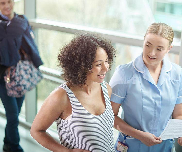 Pregnant mom touring the maternity wing with healthcare provider
