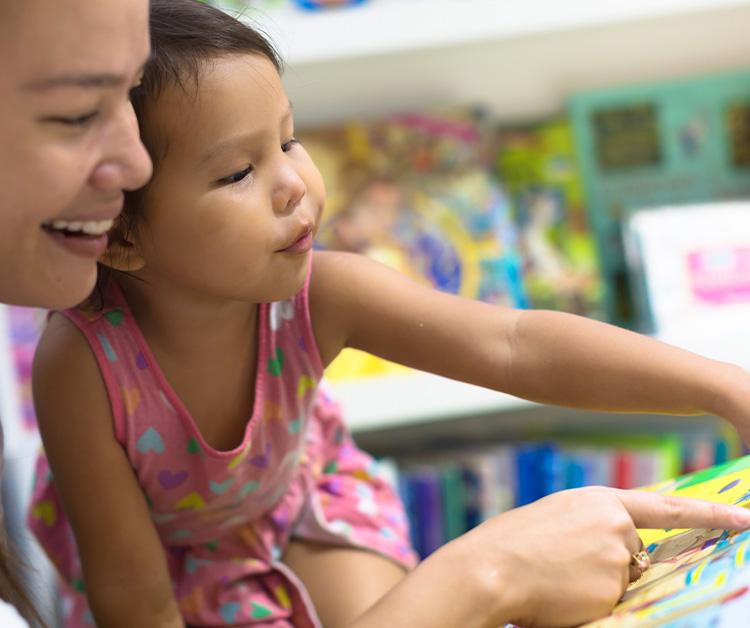 Mom and daughter reading a book