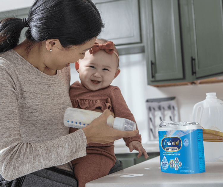 Erin Andrews holding her son with Enfamil Enspire™ Optimum Infant Formula, follow label instructions for preparation and storage
