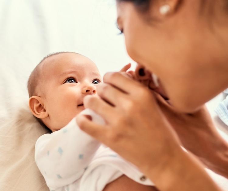 Mom Holding Newborns Hands