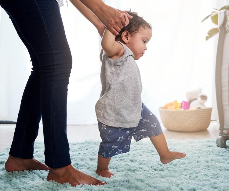 Baby walking his first steps