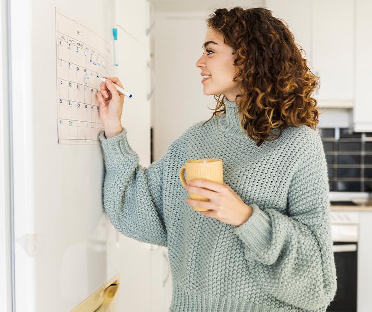 Pregnant woman marking calendar