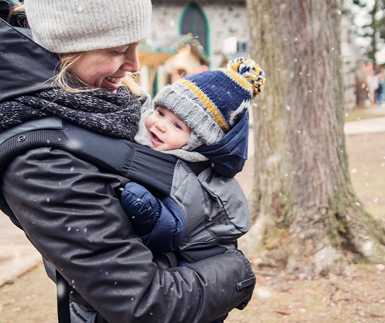 Mother holding her baby on winter