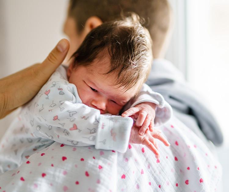 Dad comforting newborn