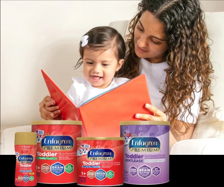 Mamá leyendo un libro con su hijo y una hilera de productos Enfagrow Toddler.