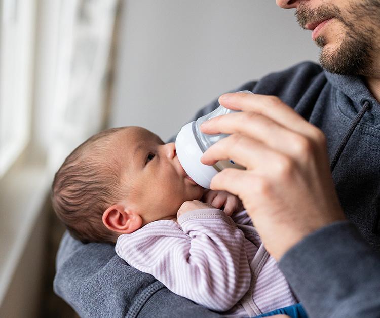 Dad bottle-feeding premature baby