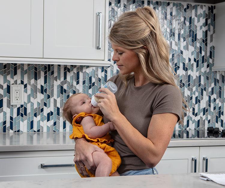 Mom giving baby a bottle
