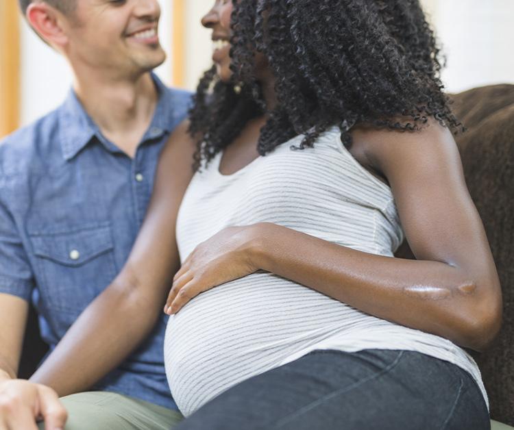 Pregnant woman looking at ultrasound image